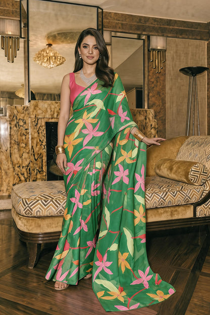 Model wearing a green floral print silk blend saree with pink, orange and yellow flowers, styled with a pink sleeveless blouse